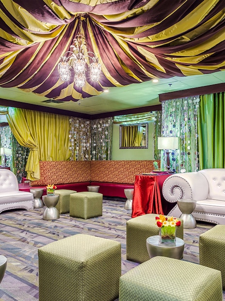 Luxurious seating area in the Green Room at Rock-A-Hula show with elegant decor and lighting.