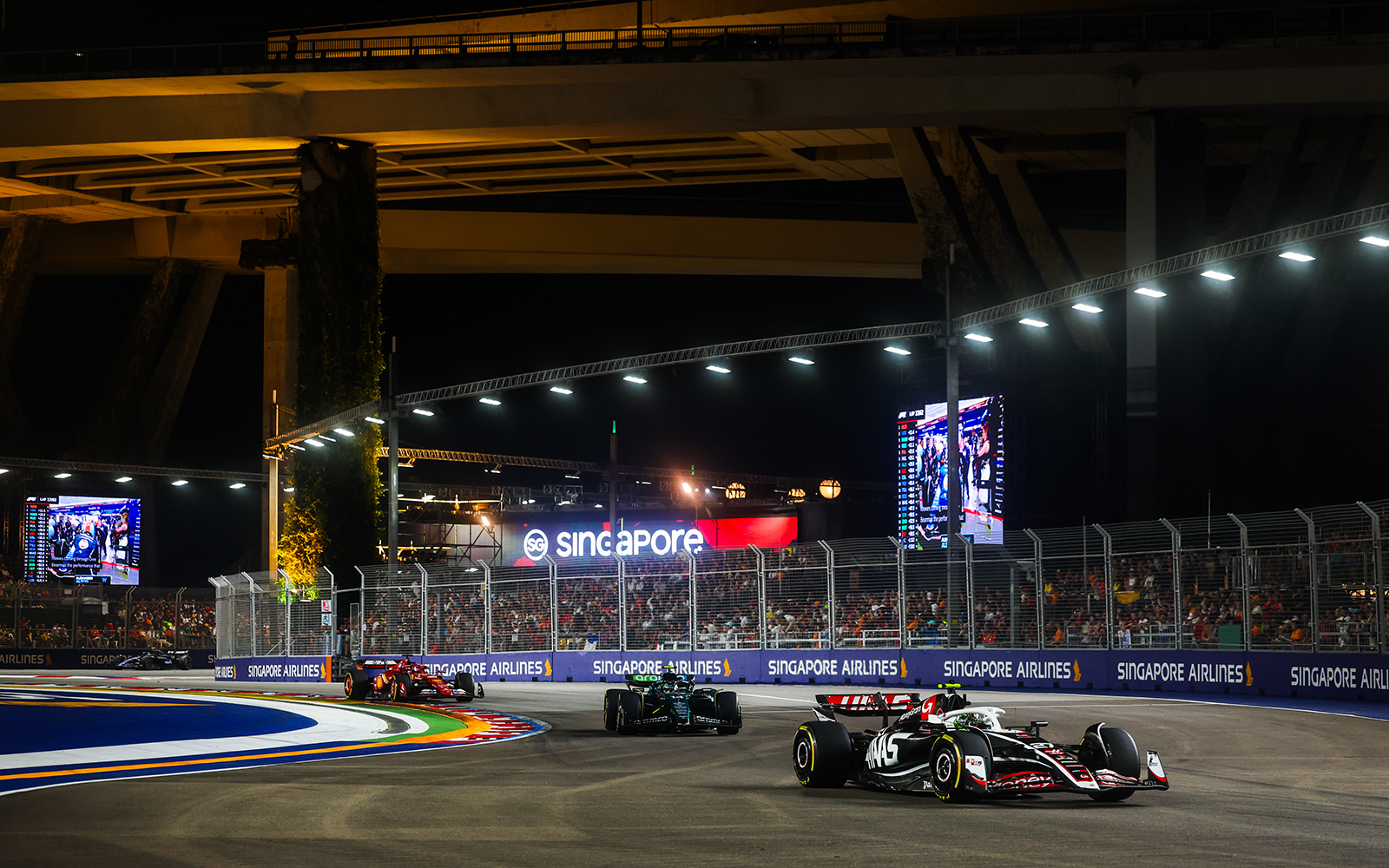 Haas' Nico Hulkenberg leads Aston Martin's Fernando Alonso, and Ferrari's Charles Leclerc at F1 Singapore