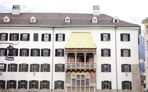 Golden Roof in Innsbruck's Old Town with mountain backdrop.