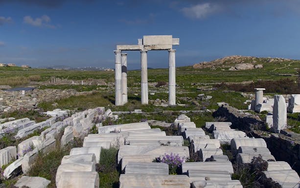 Ancient ruins and columns at Delos Archaeological Site, Greece, on a guided tour.