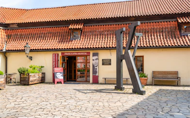 Franz Kafka Museum entrance with large K sculpture, Prague.