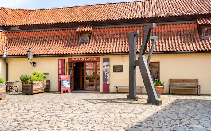 Franz Kafka Museum entrance with large K sculpture, Prague.