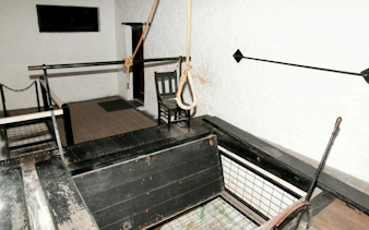 Hangman gallows with noose and chair inside Fremantle Prison.