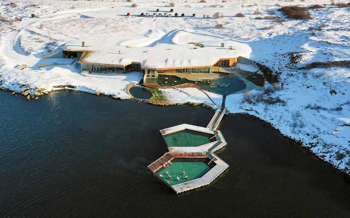 Vök Baths geothermal pools in snowy landscape, Egilsstaðir, Iceland.