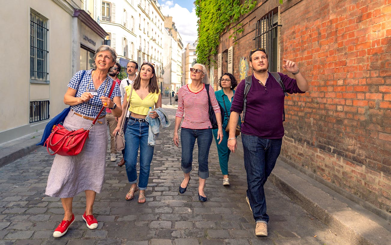 Tourists walking through Montmartre on a guided tour, Paris.