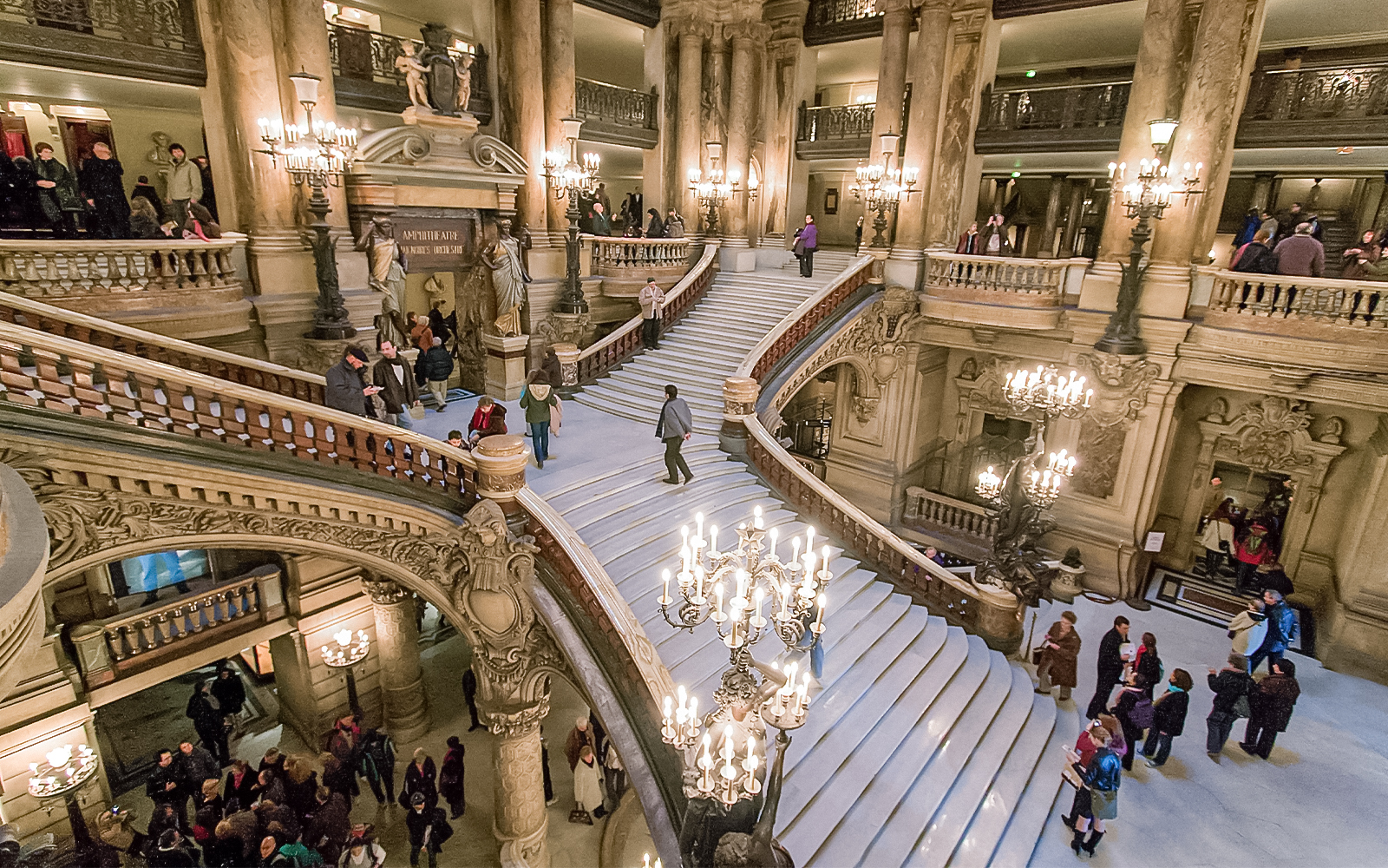 Visitors marveling at the grand staircase inside the Opera Garnier in Paris, a unique feature of the guided tour