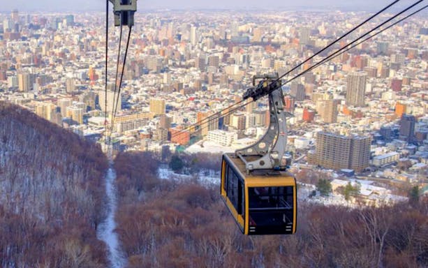Mt. Moiwa Ropeway cable car overlooking Sapporo cityscape.