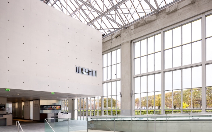 Spacious Orangerie interior with large windows and modern design.