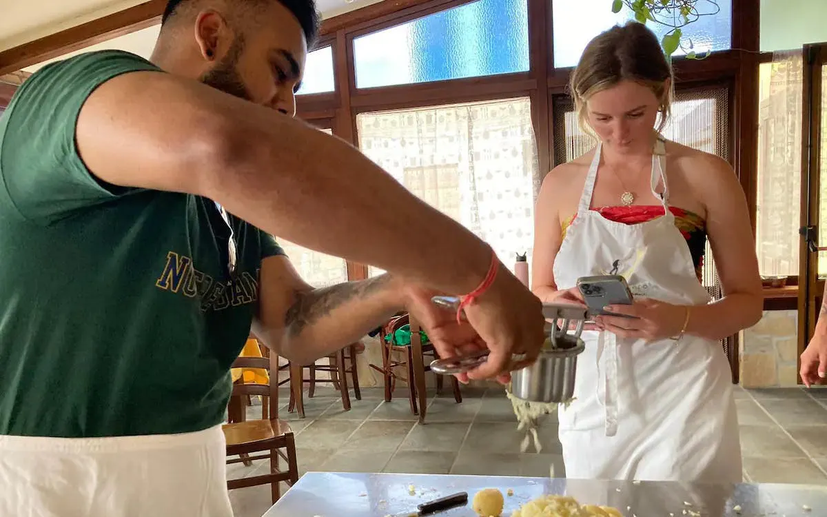 Cooking class participants making pasta at an Amalfi Coast farmhouse.