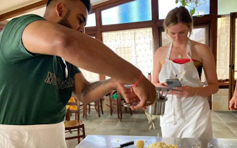 Cooking class participants making pasta at an Amalfi Coast farmhouse.
