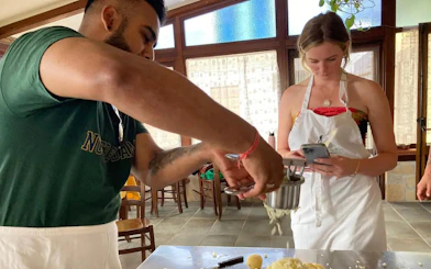Cooking class participants making pasta at an Amalfi Coast farmhouse.
