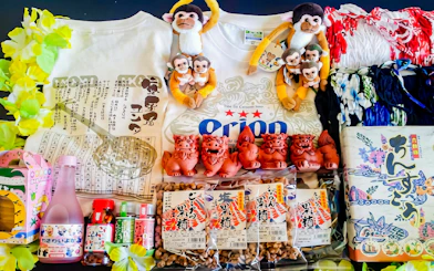 Traditional souvenirs and snacks from Ishigaki Yaima Village, including Shisa figurines and local treats.