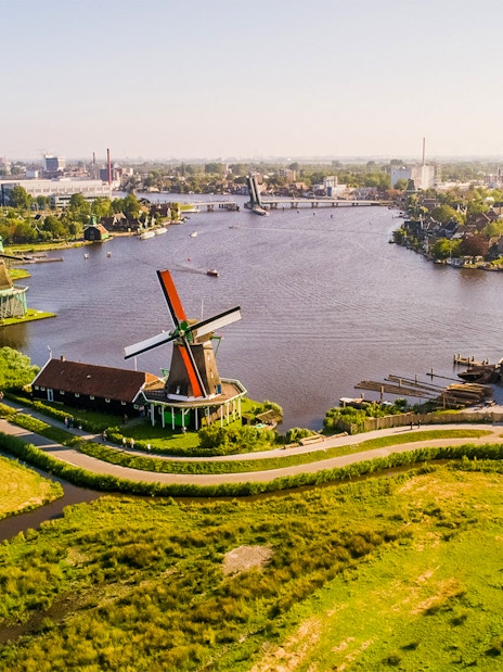 Traditional Dutch windmills along a river at Zaanse Schans, Netherlands.