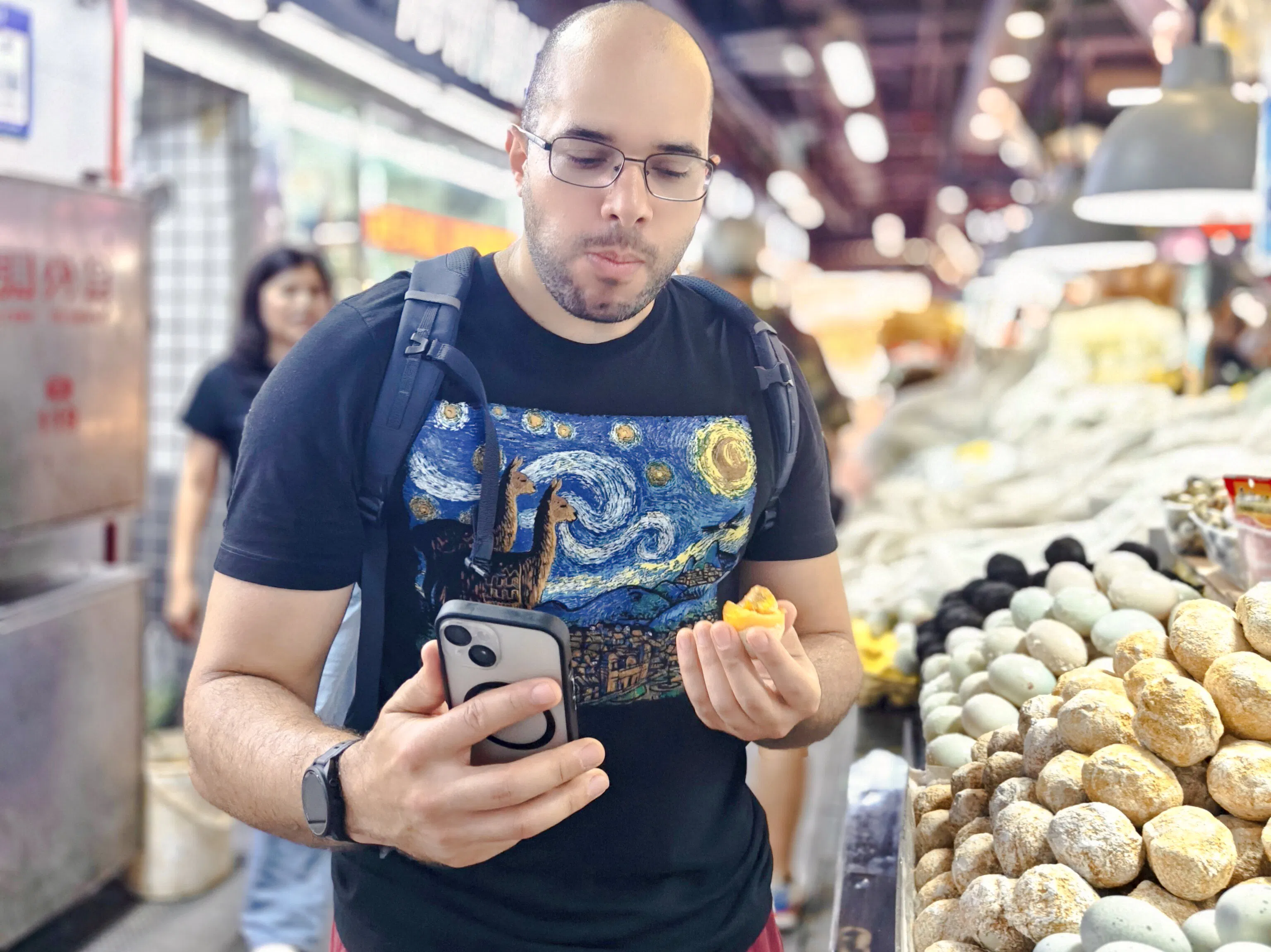 Man tasting local food at a market in Shenzhen, exploring neighborhood cuisine.