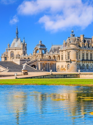 Chateau of Chantilly with reflection in the water, Paris.