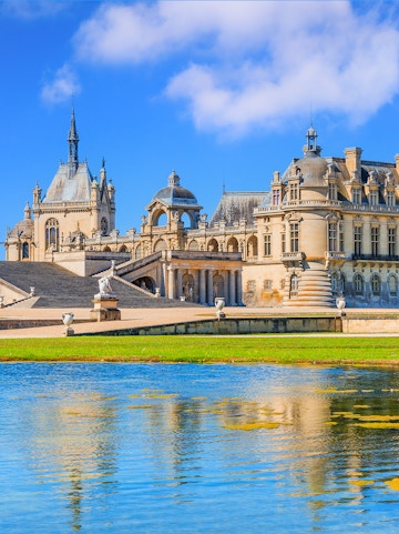 Chateau of Chantilly with reflection in the water, Paris.