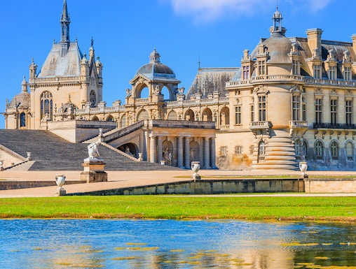 Chateau of Chantilly with reflection in the water, Paris.