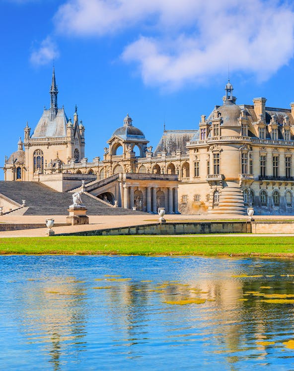 Chateau of Chantilly with reflection in the water, Paris.