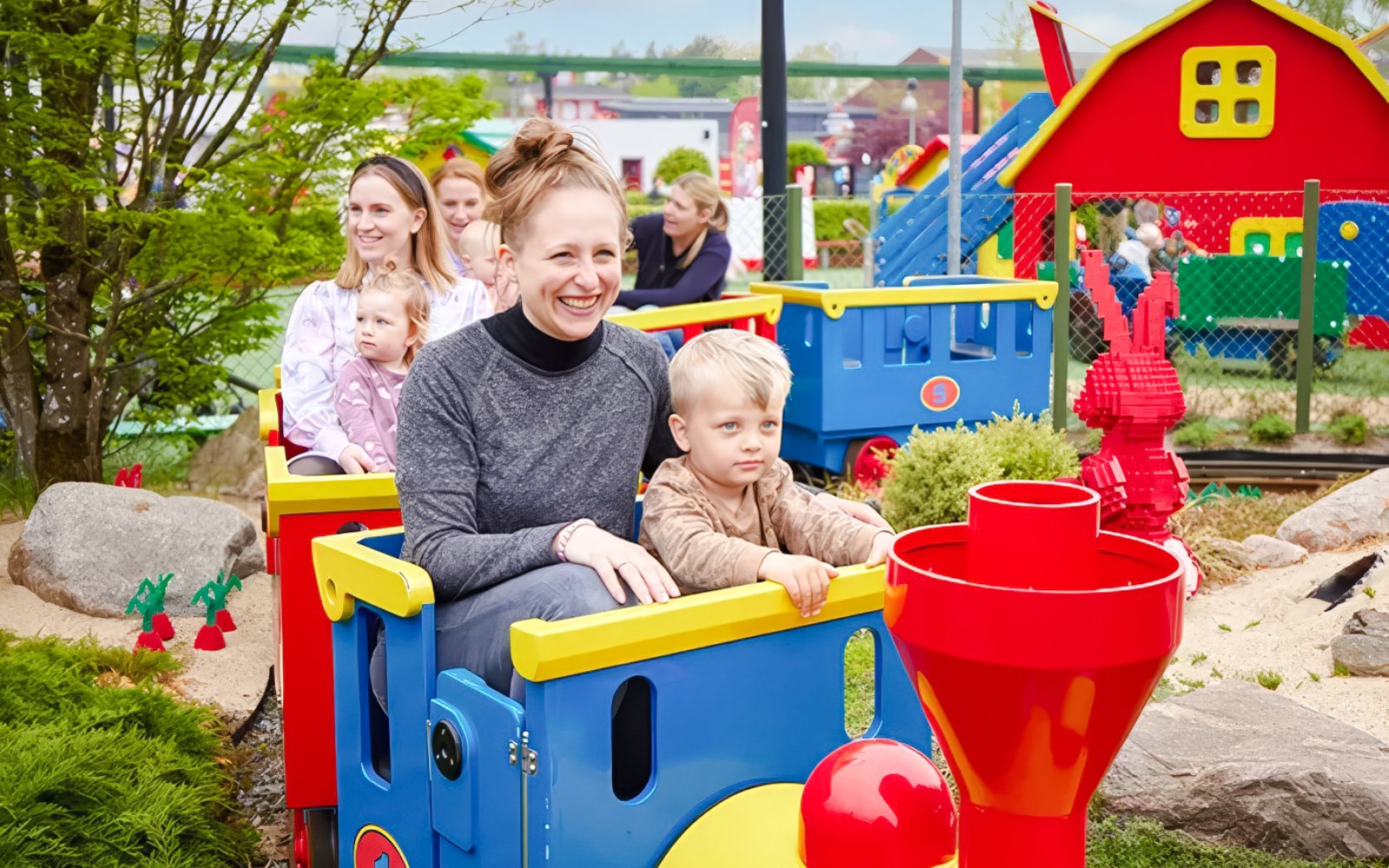 Guests riding a colorful train at LEGOLAND Billund.