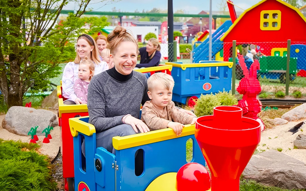 Guests riding a colorful train at LEGOLAND Billund.