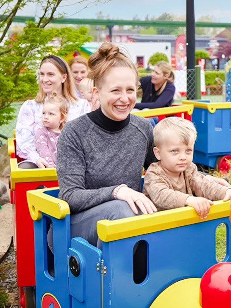 Guests riding a colorful train at LEGOLAND Billund.