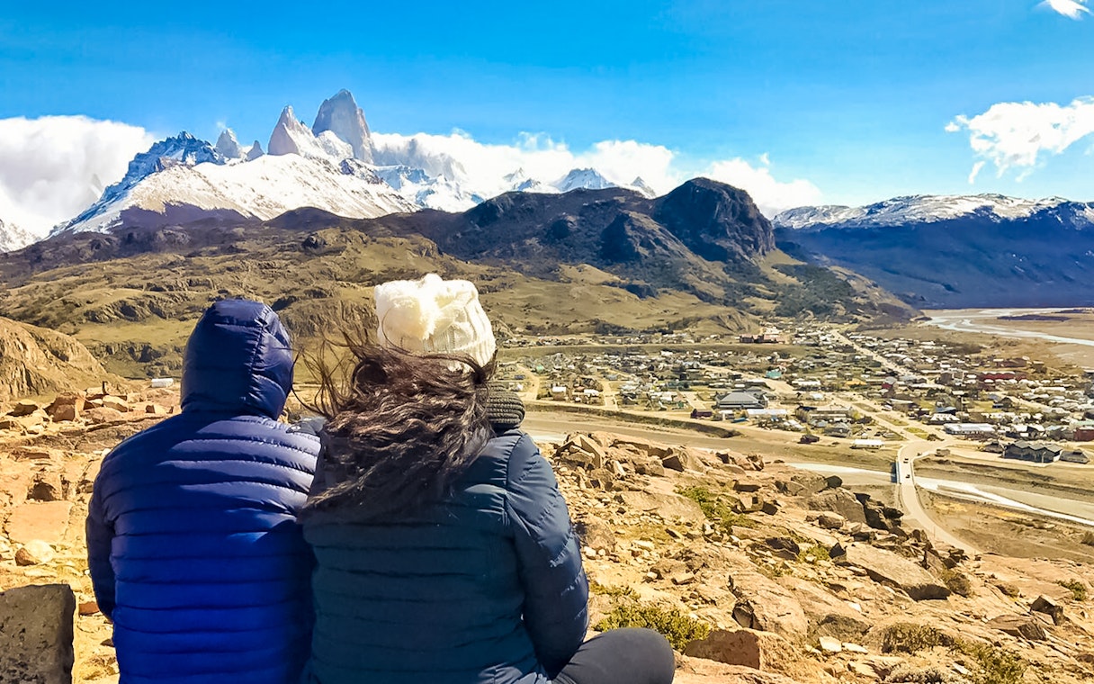 Tourists overlooking El Chaltén and Fitz Roy mountain range in Patagonia, Argentina.