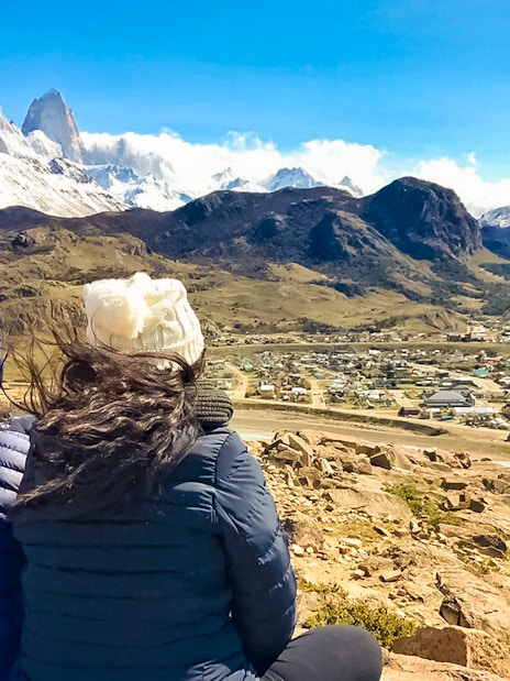 Tourists overlooking El Chaltén and Fitz Roy mountain range in Patagonia, Argentina.