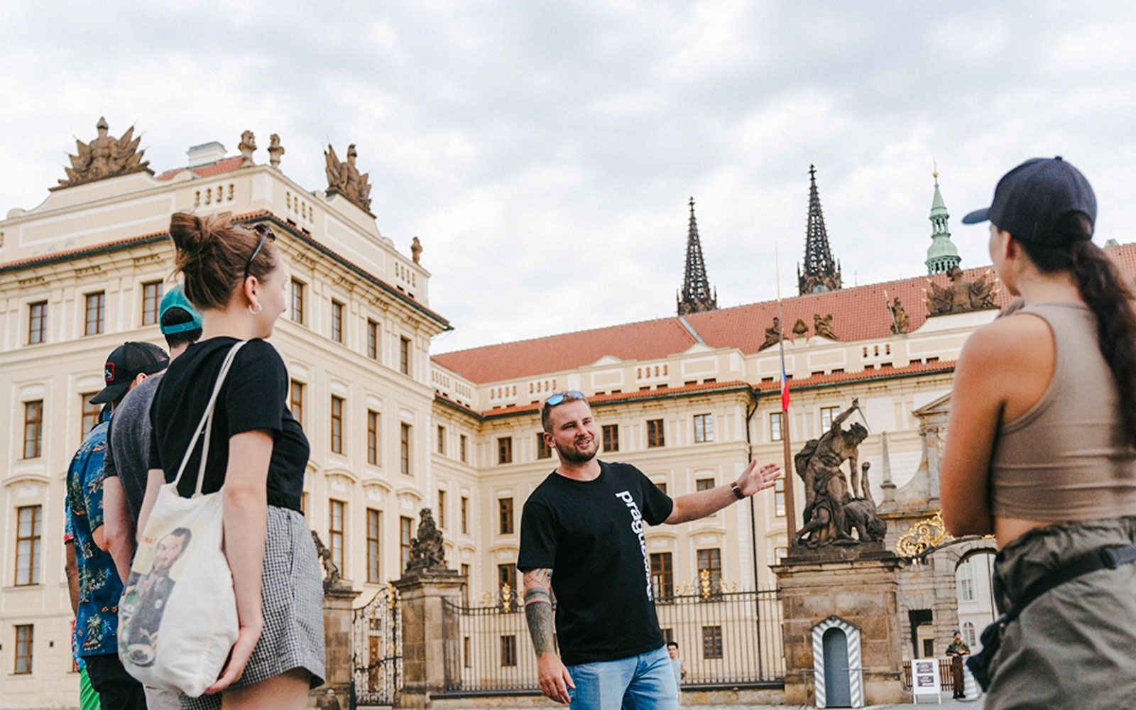 Tour guide leading a group at Prague Castle, Czech Republic.