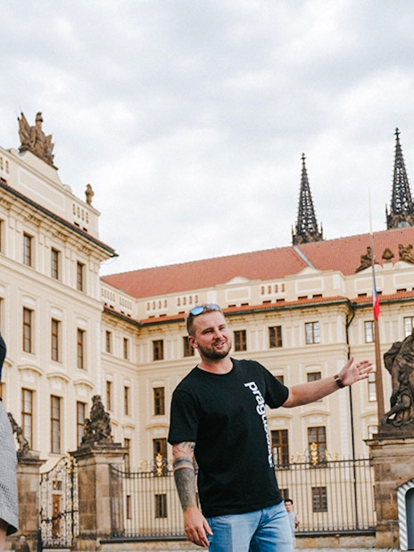 Tour guide leading a group at Prague Castle, Czech Republic.