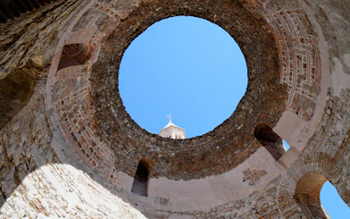 Vestibule of Diocletian's Palace with stone walls and open sky in Split, Croatia.