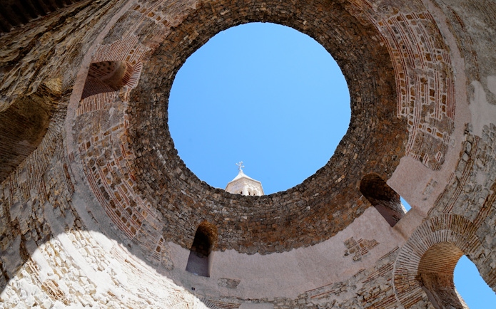 Vestibule of Diocletian's Palace with stone walls and open sky in Split, Croatia.