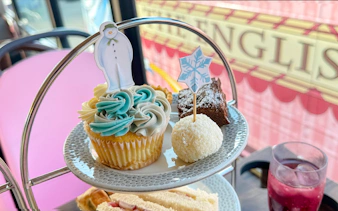 Cupcake with snowman topper on The Snowman Afternoon Tea Bus, London.
