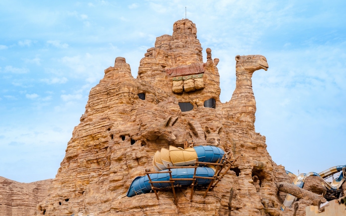 Camel-shaped rock structure with water slides at Aquarabia Water Theme Park, Qiddiya City, Saudi Arabia.