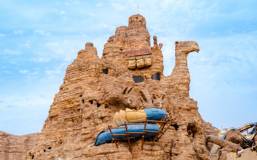 Camel-shaped rock structure with water slides at Aquarabia Water Theme Park, Qiddiya City, Saudi Arabia.