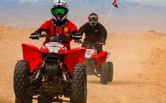 ATVs navigating sand dunes on a Las Vegas guided off-road tour.