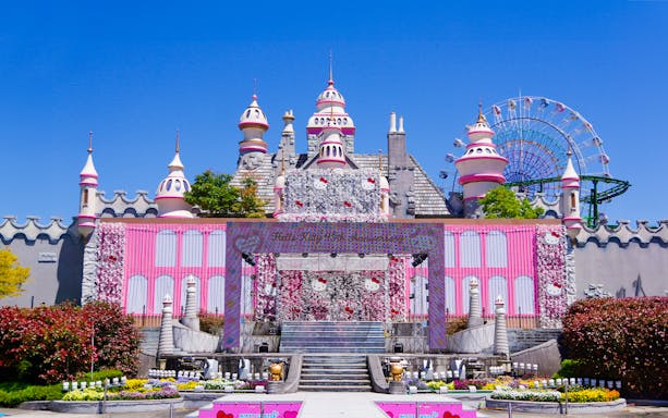 Sanrio Harmonyland entrance with Hello Kitty decorations and Ferris wheel in the background.