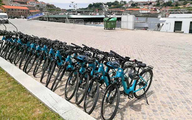 Electric bikes lined up for a guided tour along Porto's waterfront.