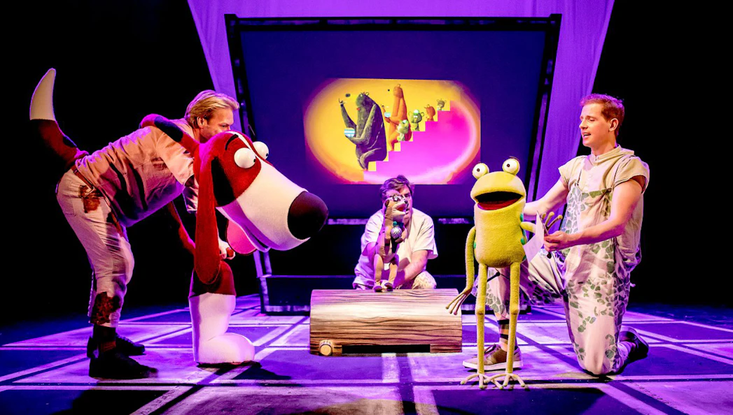 Actors performing "Oi Frog & Friends!" with large animal puppets on stage.