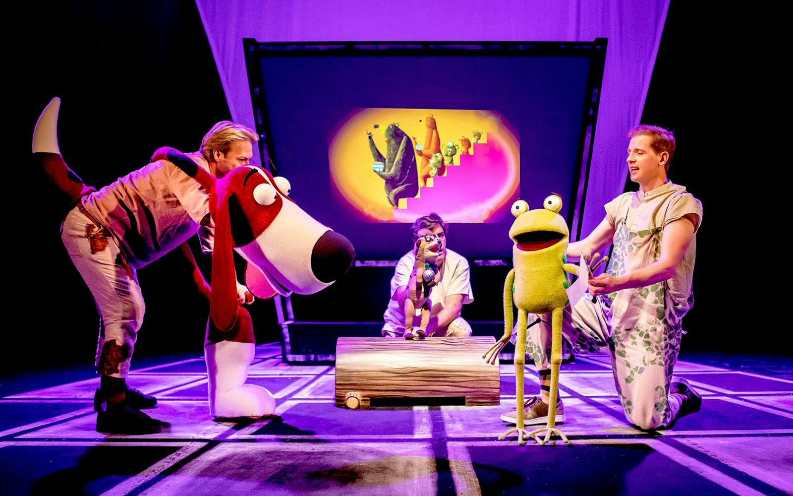 Actors performing "Oi Frog & Friends!" with large animal puppets on stage.