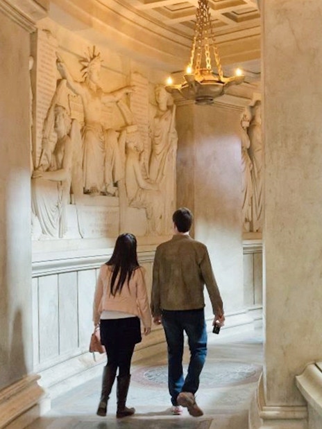 Couple walking through Invalides Napoleon's Tomb in Paris, France.
