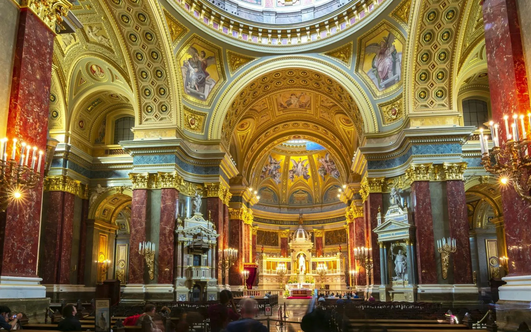 Interior of St. Stephen's Basilica in Budapest, showcasing ornate architecture and detailed frescoes.