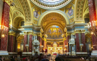 Interior of St. Stephen's Basilica in Budapest, showcasing ornate architecture and detailed frescoes.
