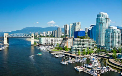 Vancouver skyline with Burrard Bridge and marina, part of Gastown's self-guided city exploration game.