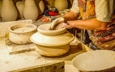 Pottery artisan shaping clay on a wheel in Avanos, Turkey.