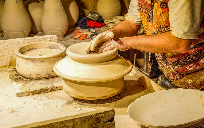Pottery artisan shaping clay on a wheel in Avanos, Turkey.