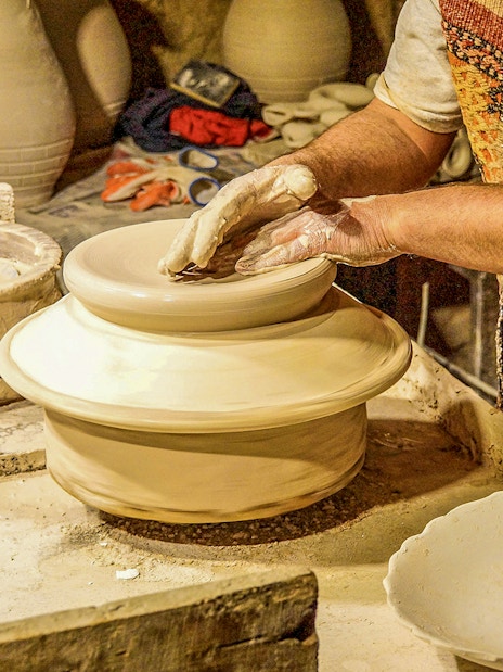 Pottery artisan shaping clay on a wheel in Avanos, Turkey.