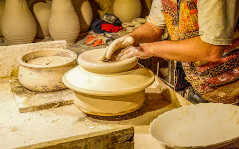 Pottery artisan shaping clay on a wheel in Avanos, Turkey.