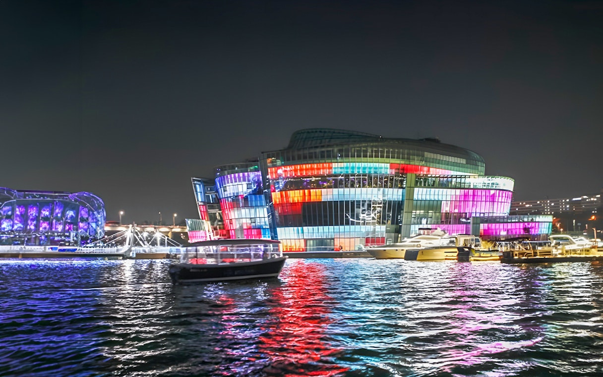 Yachts on Han River at night with colorful lights, Seoul Golden Blue Marina.