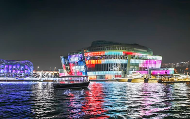 Yachts on Han River at night with colorful lights, Seoul Golden Blue Marina.