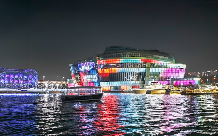 Yachts on Han River at night with colorful lights, Seoul Golden Blue Marina.